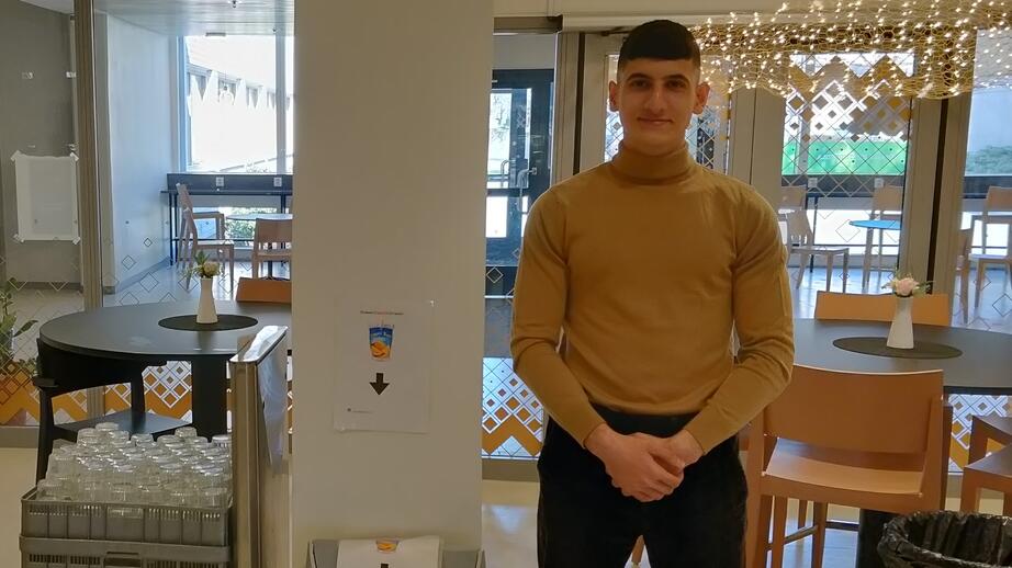 Jude Hwaijeh visar upp returstationerna som UF-företaget har placerat ut i skolan. Alla förpackningar rengörs och blir sedan till väskor.